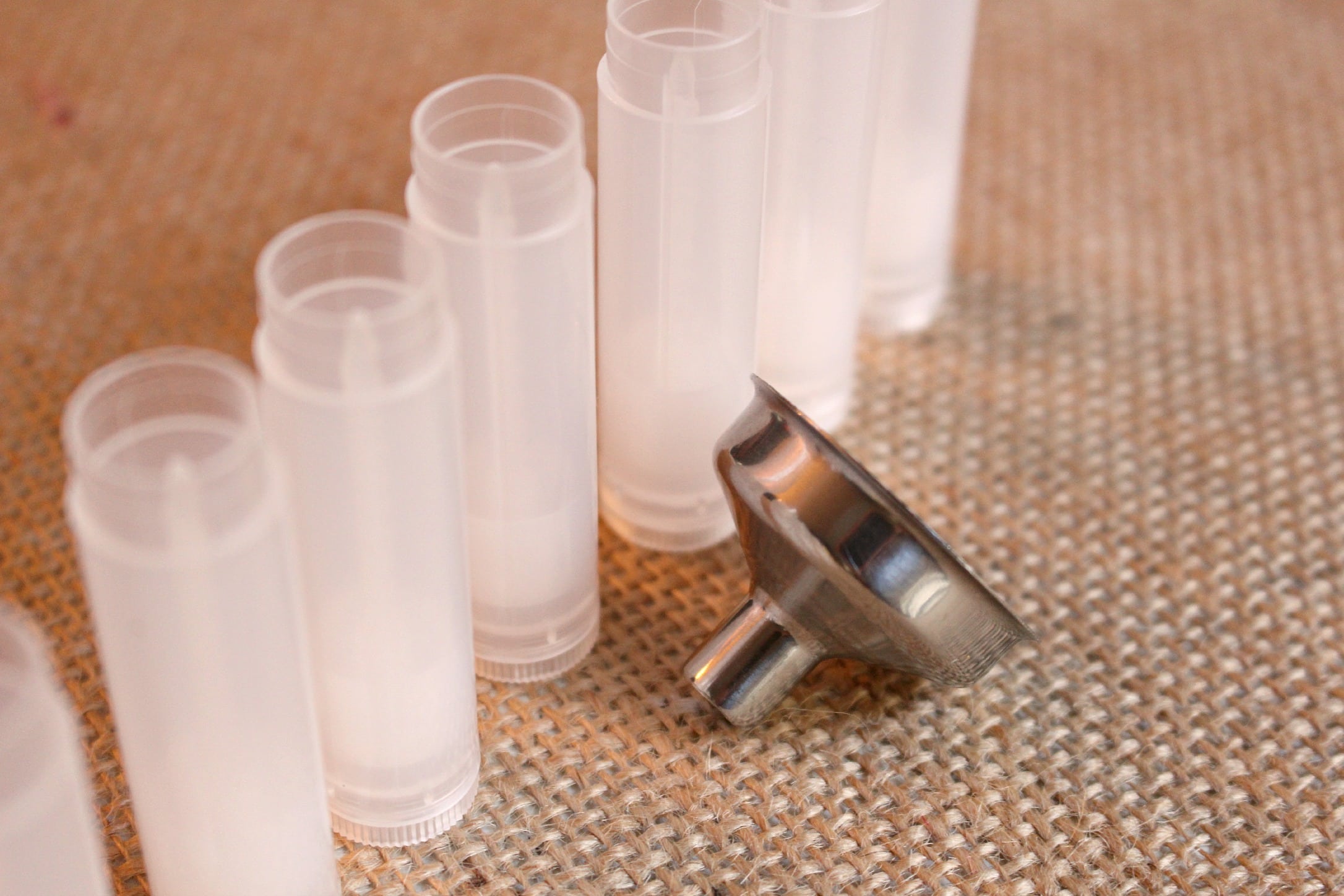 How to Make Lip Balm: Empty tubes and a small metal funnel for making lip balm at home